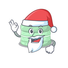Pistachio macaron in Santa cartoon character style with ok finger