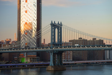 Manhattan Downtown skyline panorama with manhattan bridge foreground from Brooklyn Bridge Park riverbank