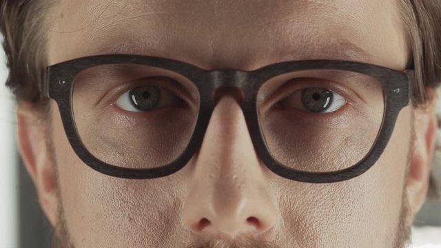 Business man in a suit and glasses looks at the camera, portrait of a man, ProRes 4k.