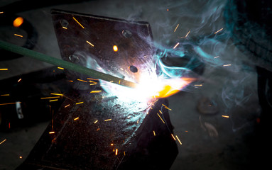 Fototapeta na wymiar Sparks from welding at a construction site