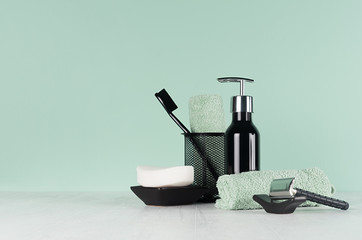 Elegant men dressing table in trend green mint menthe color - black razor, toothbrush, soap, towel,...
