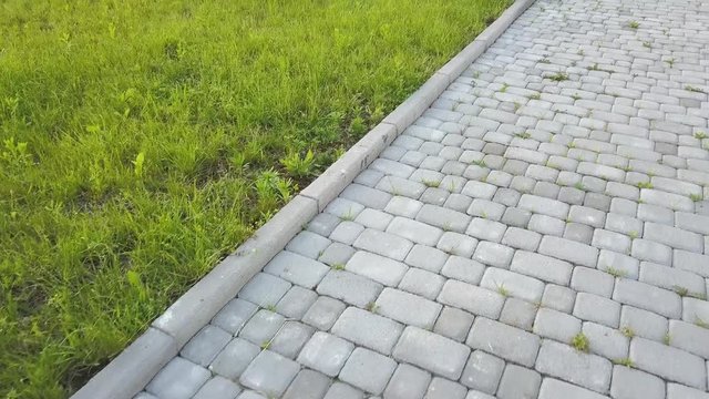 Close-up of slab stone paved path way at park or backyard. Walkway footpath road at house yard garden.