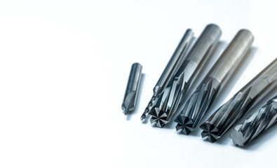 Special tools isolated on white background. Made to order special tools. Coated step drill, reamer, and endmill detail. HSS cemented carbide. Carbide cutting tool for industrial applications.