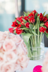 Red Tulips in a Vase at a Flower Stand - 328228126
