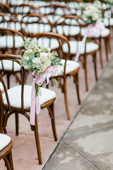 Flowers Decorating Chairs at a Wedding Ceremony - 328228163