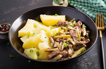Stew beef, pieces of beef stewed with pickled cucumber in russian style. Beef stroganoff and boiled potatoes.