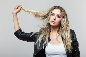 Portrait of young female with black leather jacket.