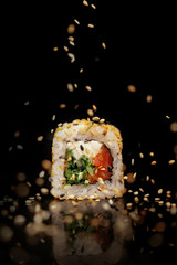 Traditional Japanese sushi on a black glossy background