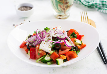 Trendy salad. Greek salad  with fresh vegetables, feta cheese and black olives.  Healthy balanced eating.