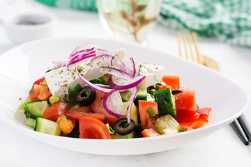 Trendy salad. Greek salad  with fresh vegetables, feta cheese and black olives.  Healthy balanced eating.