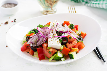 Trendy salad. Greek salad  with fresh vegetables, feta cheese and black olives.  Healthy balanced eating.
