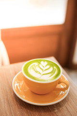 Cup of Matcha green tea latte in cafe