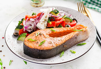 Ketogenic lunch. Baked salmon garnished with greek salad. Healthy dinner. Keto/paleo diet.