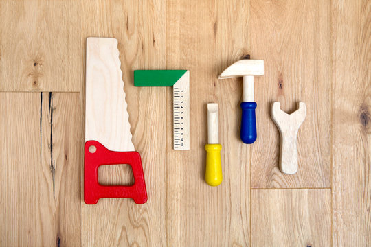 wooden tool toy set on hardwood floor