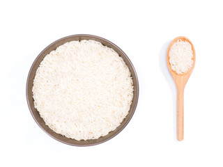 Indian long grain Basmati rice in brown ceramic bowl and wooden spoon isolated on white. Indian cuisine, ayurveda, naturopathy concept