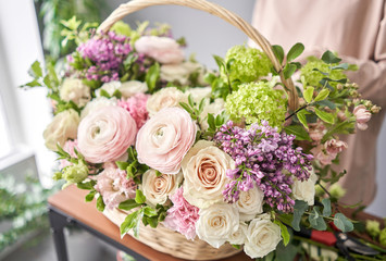 Spring bouquet in a wicker basket.. Learning flower arranging, making beautiful bouquets with your own hands. Flowers delivery