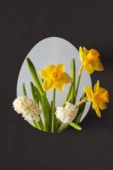 Easter composition made of spring flowers in the shape of an egg.