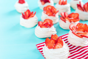 strawberry pavlova topped with fresh cream and strawberries