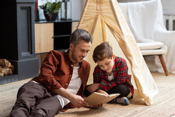 father and son spend time together read book