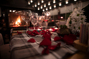 elegance wedding proposal table with rose petals and wine glasses