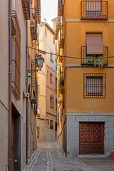 Cozy medieval cobbled narrow street in Toledo. Spain