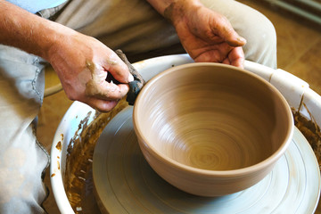 Working process of loam item in workshop. Man working in home studio. Craftsman at work.