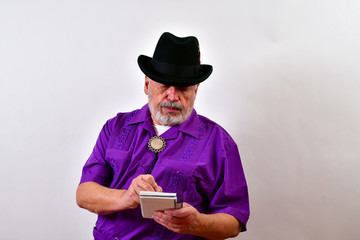 Serious old man is writting in his notebook..Elderly gentleman taking notes.