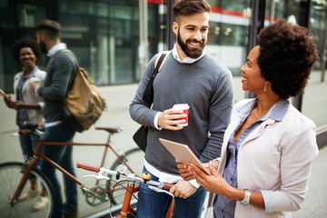 Business people discussing and smiling while walking together outdoor