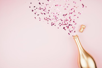 Bottle of champagne and confetti. 