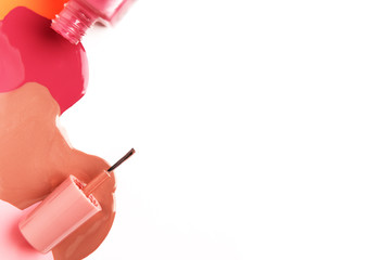 Paintbrush with poured liquid isolated on white background. Glass bottle with nail polish. Copy...