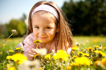 Cute little girl on a meadow