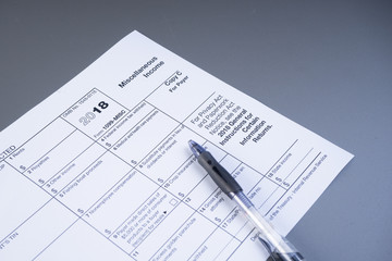 Tax or taxation concept. The tax form is for US citizens and internationals staying in the USA to file their tax return. Complemented by finance accessories and props.