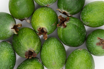 Green feijoa fruits isolated on white background. Scientific name Acca sellowiana. Top view. Healthy and balanced diet eating concept. Fresh fruits concept.