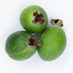 Green feijoa fruits isolated on white background. Scientific name Acca sellowiana. Top view. Healthy and balanced diet eating concept. Fresh fruits concept.