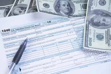 Obraz premium Tax or taxation concept. The tax form is for US citizens and internationals staying in the USA to file their tax return. Complemented by finance accessories and props.