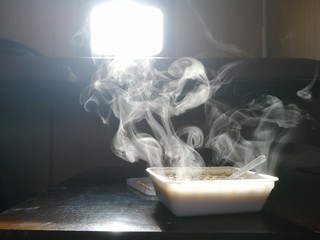 cup of tea with smoke on black background