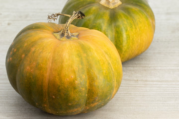 Pumpkins on a wooden table in fall garden background. Autumn.
