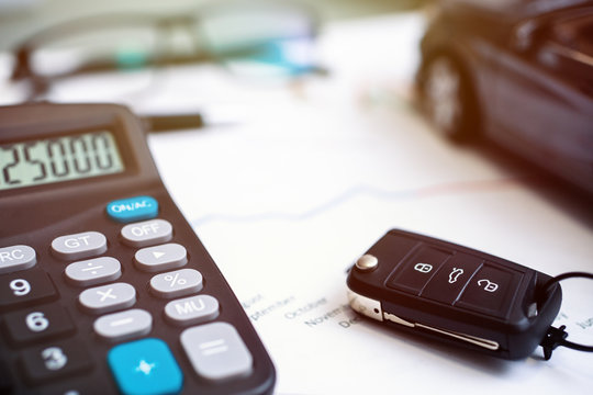 car sales chart concept visual. car keys, graphics and calculator
