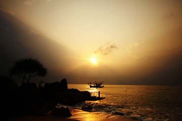 Sunset on the sea and a boat sailed.