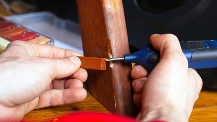 restoration repair wood surface on furniture sealing scratches and chips set of tools close-up