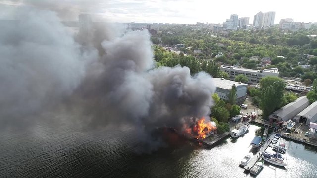 big fire with black smoke aerial top panoramic view sky fly