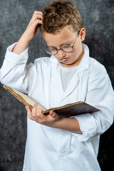 cheerful boy retro with a white blouse reading book