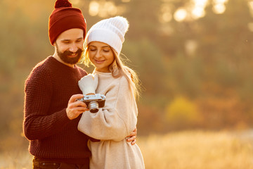 Friends looking at photos on camera with copy space