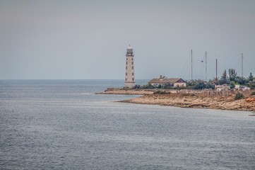 Fototapeta premium Chersonesskiy lighthouse, Sevastopol, Crimea, Russia. Cloudy weather
