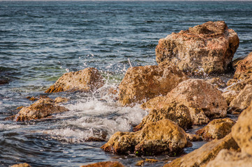 Splitting waves against picturesque rocks in the sea
