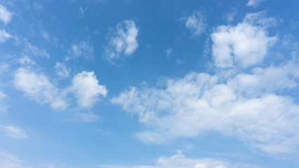 Beautiful white fluffy clouds on vivid blue sky in a sunny day