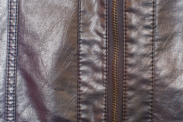 Naklejka premium Fragment of leather fabric with stitched inserts and zipper