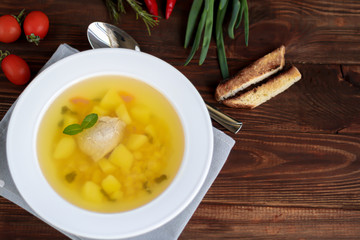 Chickpea soup on a wooden background. Near red chilli greens.