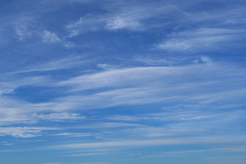 Bright beautiful blue sky with soft clouds for background or texture
