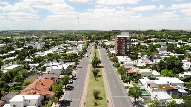 Aerial panoramic view of Colonia del Sacramento, Uruguay, drone flying over Baltasar Brum avenue on a windy day